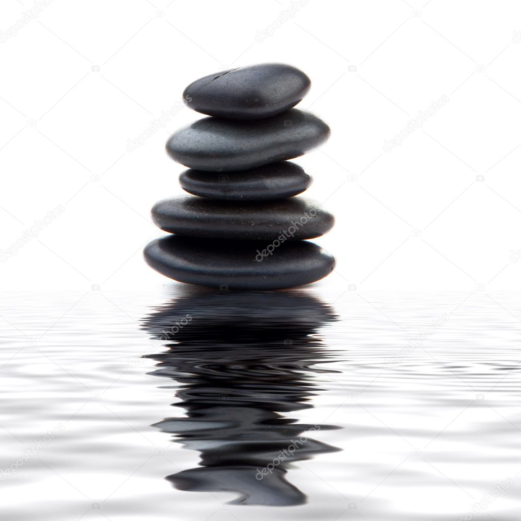 Zen stones. Black massage stones stacked, isolated.