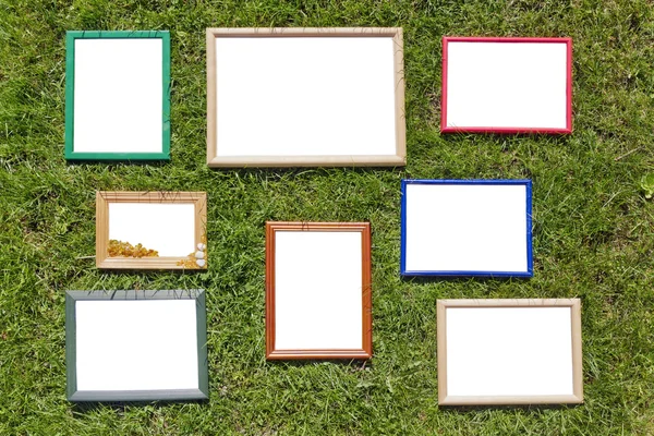 Wooden photo frames on spring lawn