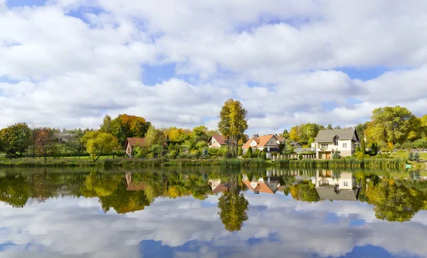 Dream autumn village and its reflection — Stock Photo, Image