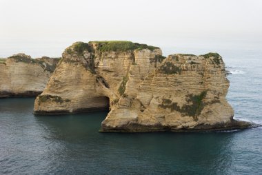 Lone rocky uninhabited island clipart