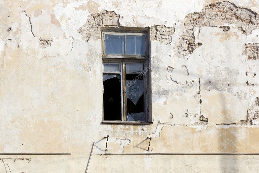 Broken window in abandoned house