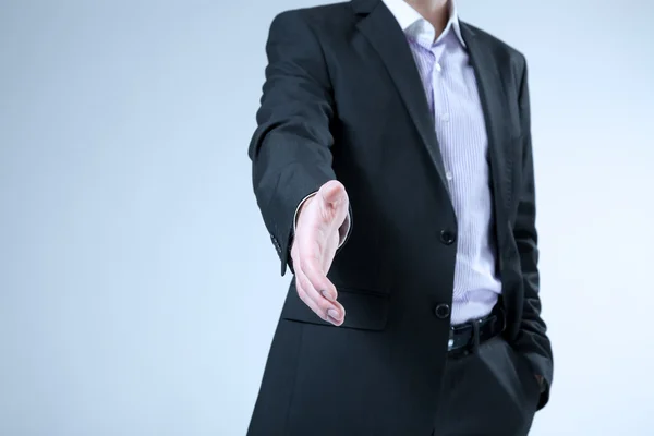 Businessman stretches out hand for handshake. Hello, welcome, offer, contract, agreement etc. classic business concept. No head, no face on the shot — Stock Photo, Image
