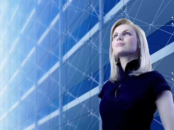 Attractive blonde standing by the skyscraper — Stock Photo, Image