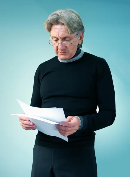 Senior man reading important papers. Attractive seniors lifestyle in studio uniform background series. — Stock Photo, Image