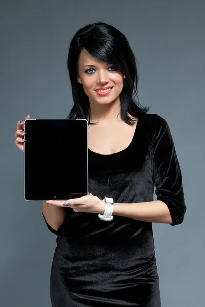 Sexy smiling brunette presents new touch pad device. Portrait mode blank space to place your text logo product. One of collection. — Stock Photo, Image