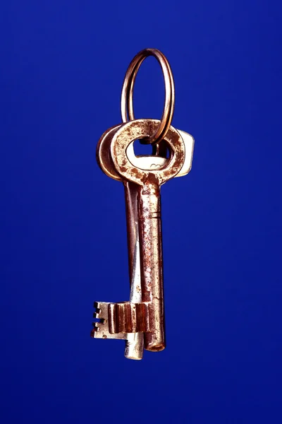 Keys for door lock on blue background — Stock Photo, Image