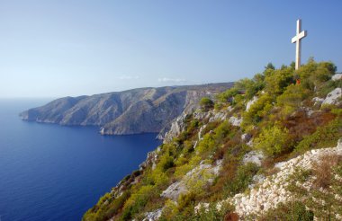 Cross on cliff face on Zakynthos island clipart