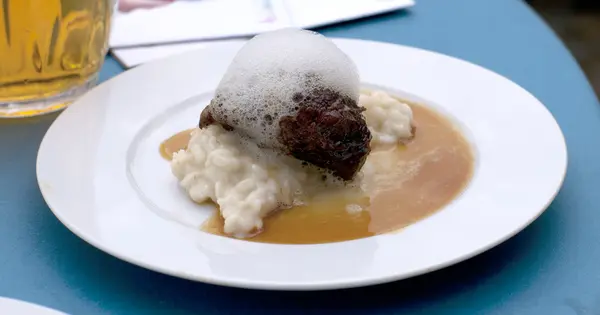 stock image Glazed cheek of Iberian pork in sherry and cream with rice and m