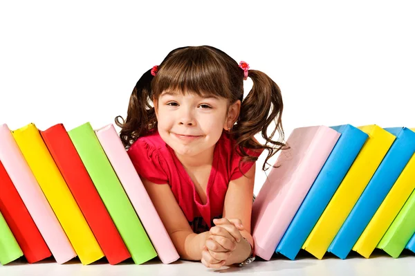Happy little girl with books on the floor Stock Image
