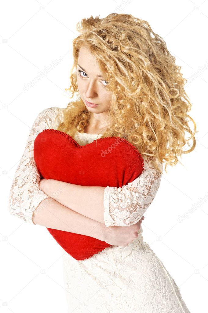Attractive young woman holding heart