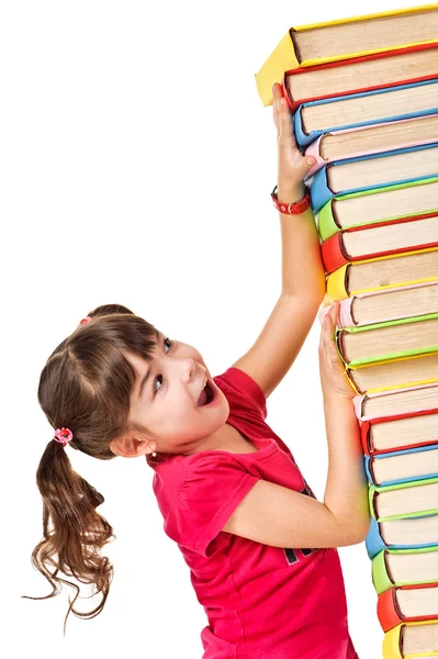 Školačka s klesající hromadu knih — Stock fotografie