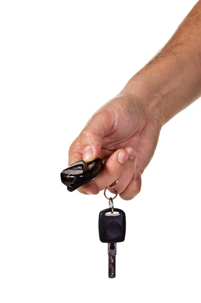 Mão segurando chaves do carro e um contro remoto — Fotografia de Stock