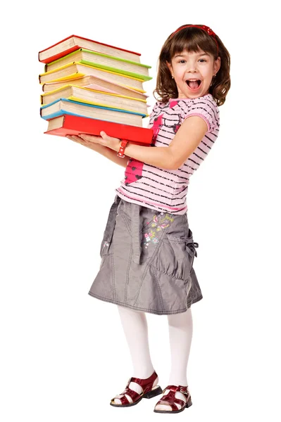 Feliz colegiala con un montón de libros pesados — Foto de Stock