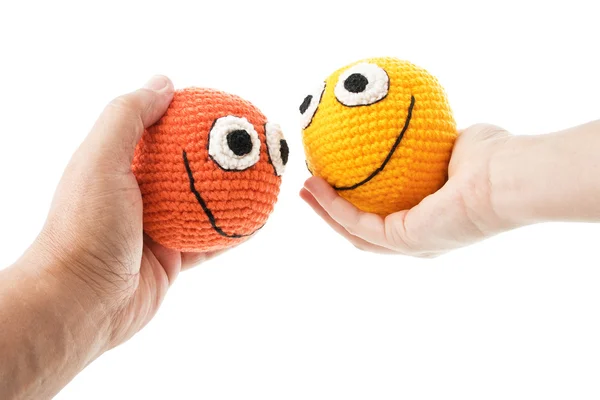 Two smileys in woman and man hands — Stock Photo, Image
