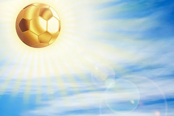 Golden football ball shining over sky. — Stock Photo, Image