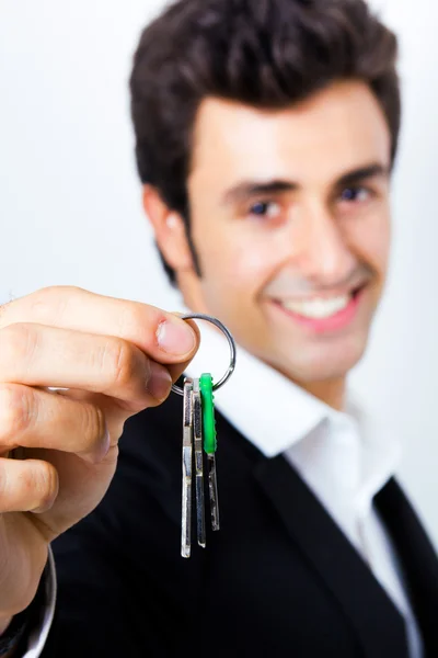 stock image Attractive young man showing some keys