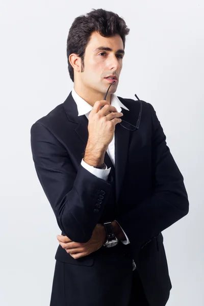 Expressive businessman in black suit and glasses — Stock Photo, Image