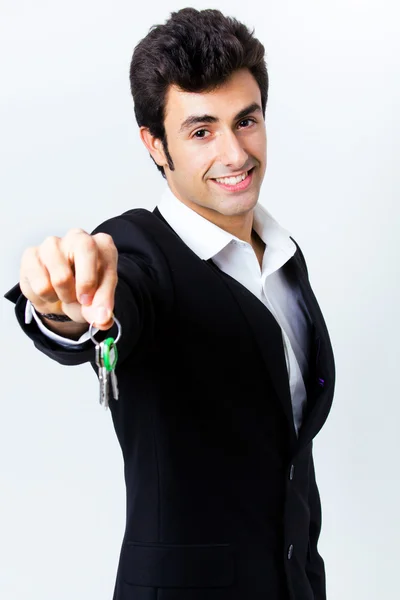 Attractive young man showing some keys Stock Picture