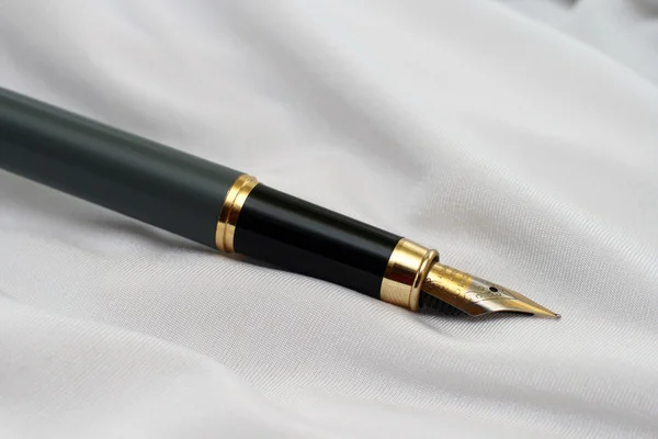 stock image Fountain pen on satin