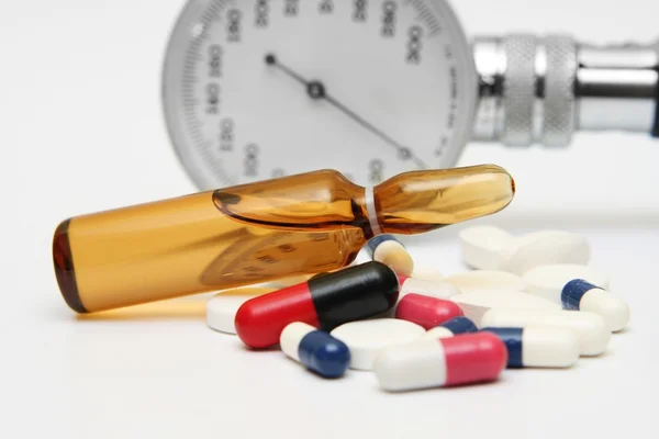 Pills and medicine vial — Stock Photo, Image