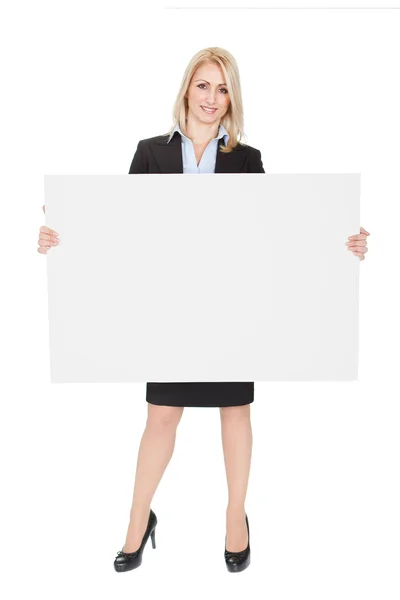 Cheerful businesswomen presenting empty board — Stock Photo, Image