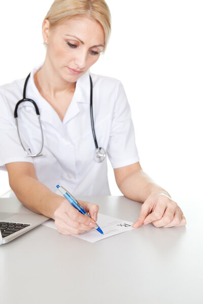 Cheerful medical doctor woman filling out prescription. Isolated on white