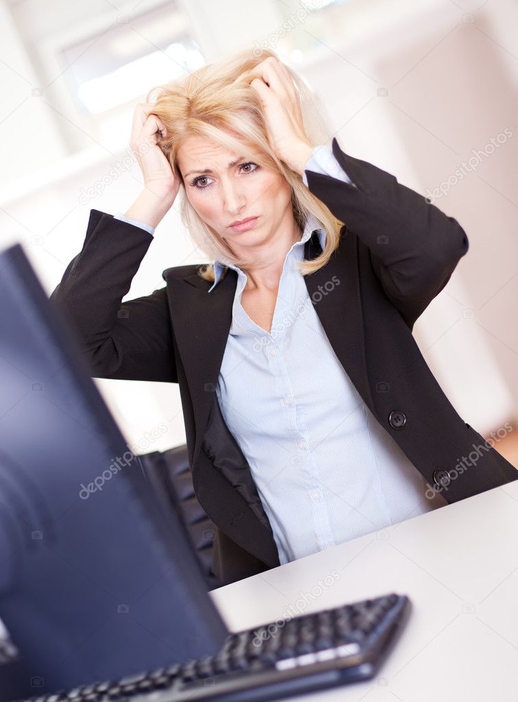 Stressful business woman working on computer