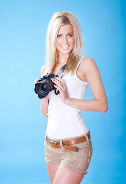 Portrait of beautiful young woman with camera — Stock Photo, Image