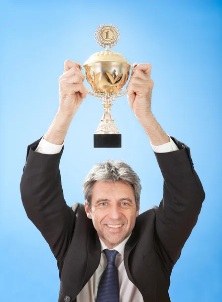 stock image Senior businessmen holding a trophy