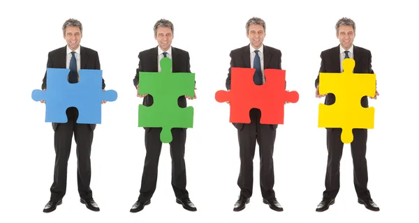 Group of business holding jigsaw puzzle — Stock Photo, Image
