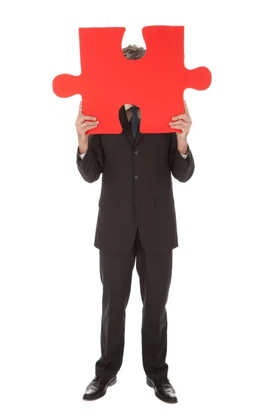 Senior businessman holding a jigsaw puzzle — Stock Photo, Image