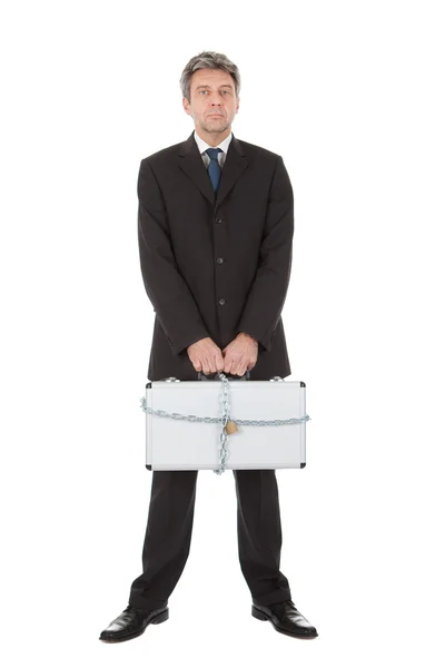 Businessman holding metal suitcase — Stock Photo, Image