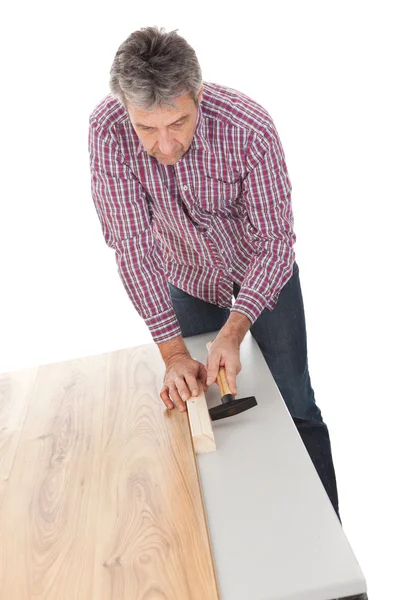 Worker assembling laminate floor — Stock Photo, Image