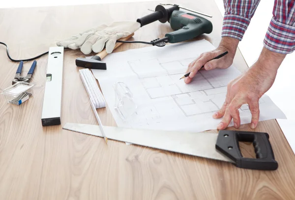 Worker looking into a house plan — Stock Photo, Image