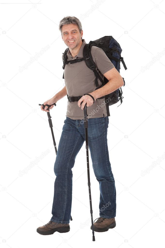 Senior man with backpack and hiking poles