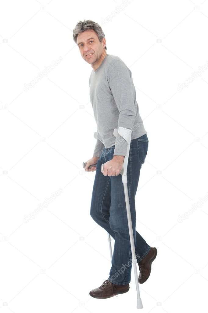 Senior man walking using crutches