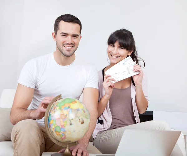 Casal jovem comprando bilhetes de viagem online — Fotografia de Stock