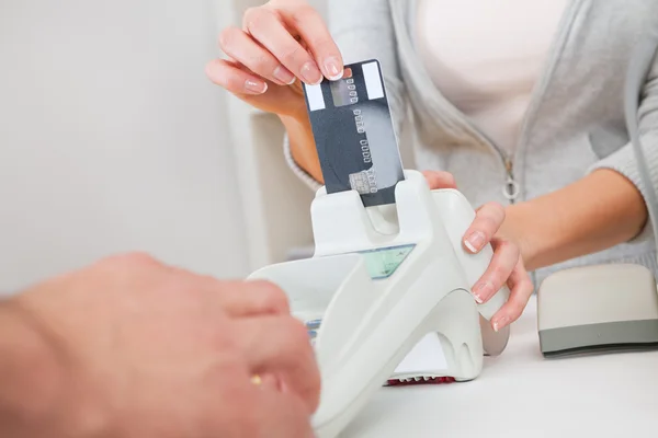 stock image Sales person inserting card into scanner