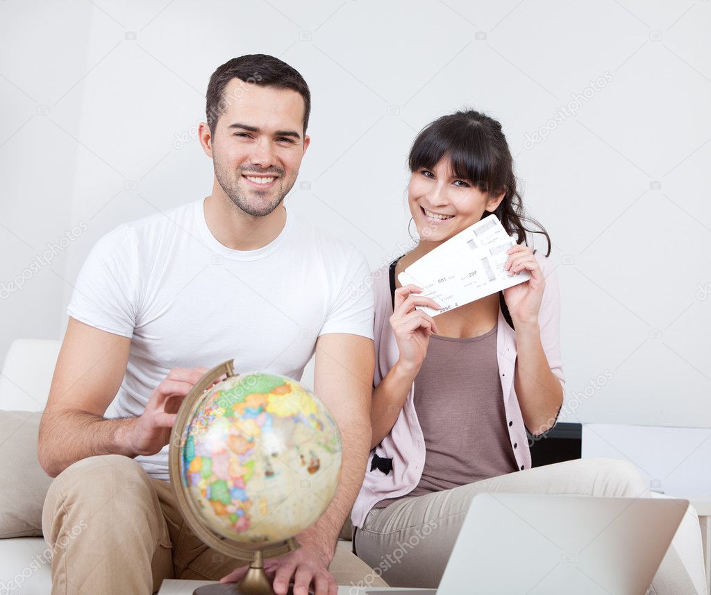 Young couple buying travel tickets online