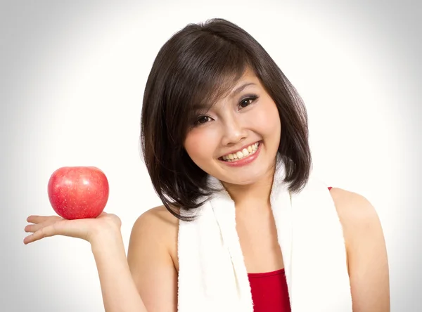 在她的手上显示一个苹果的漂亮亚洲女人 — 图库照片