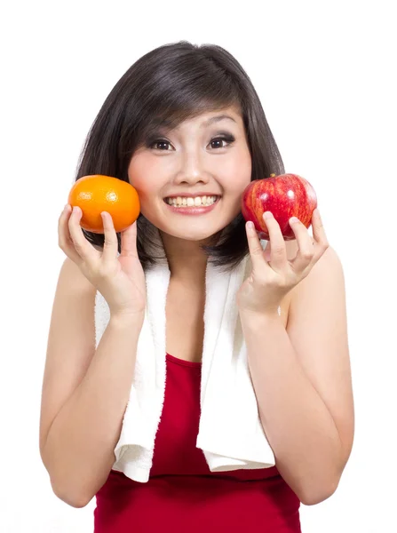 Pretty young girl showing orange and apple — Stock Photo, Image