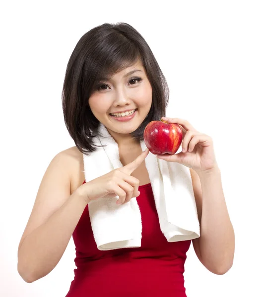Pretty young female with apple and towel after exercise — Stock Photo, Image