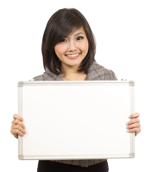 Pretty young businesswoman showing blank whiteboard — Stock Photo, Image