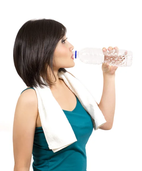 Красивая молодая женщина пьет бутылку воды после тренировки — стоковое фото
