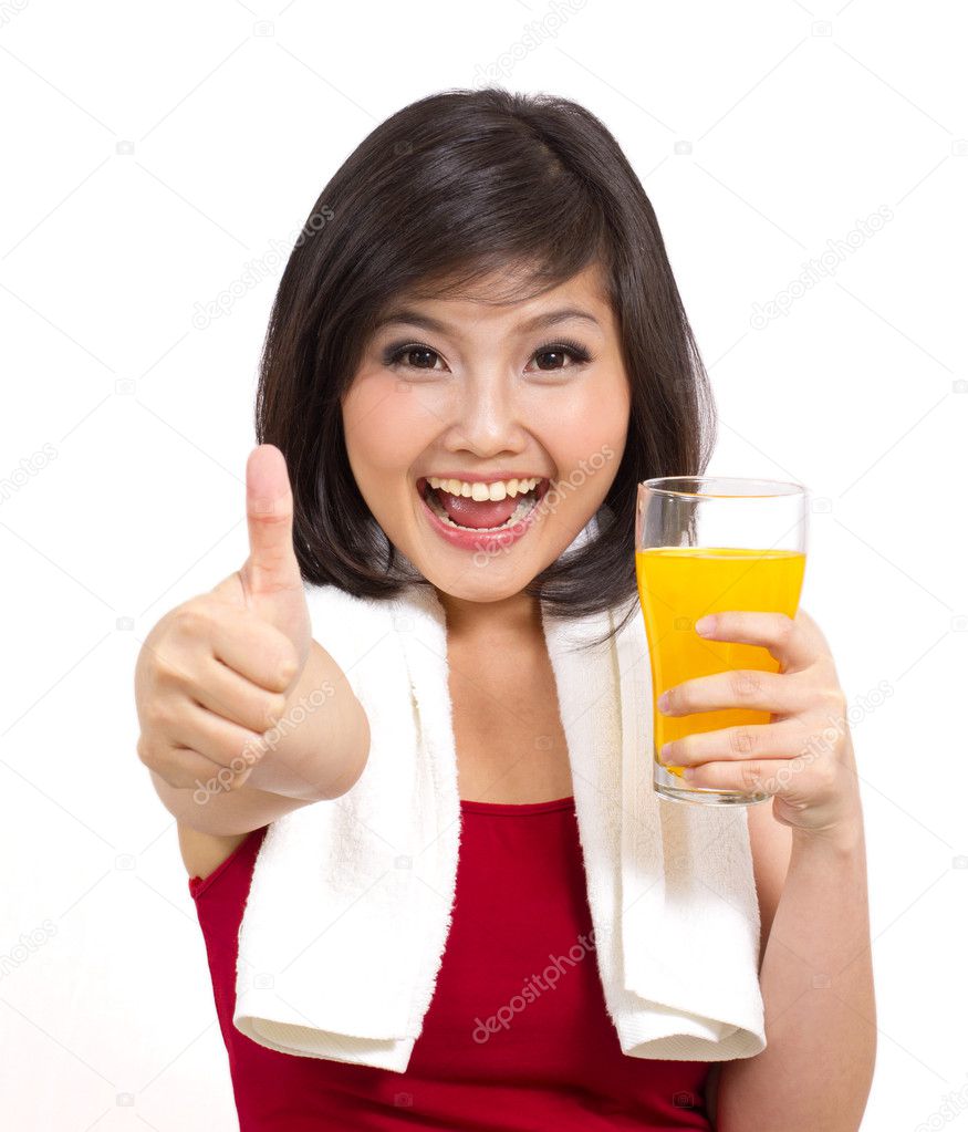 Pretty asian girl holding orange juice and thumbs up