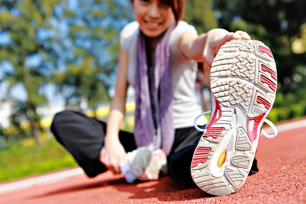 stock image Sporty asian girl doing stretching exercise