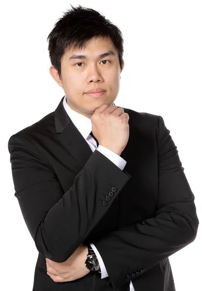 Молодой азиатский бизнесмен думает: — стоковое фото