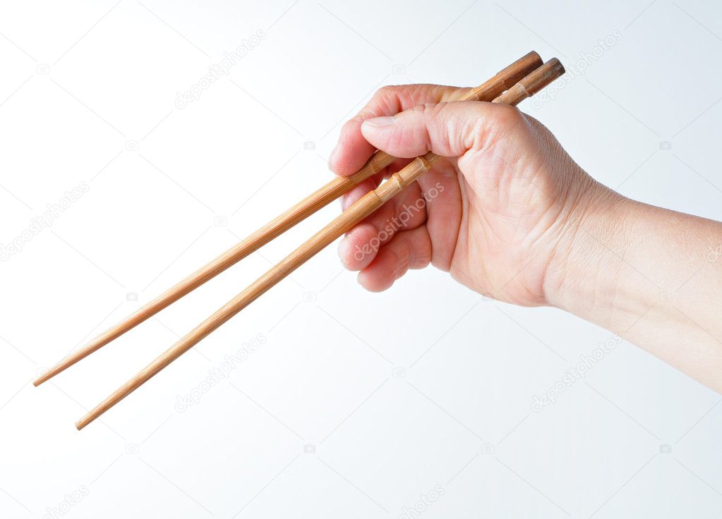 Hand using chopsticks