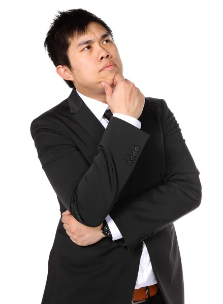 Młody azjatycki biznes człowiek myśli — Zdjęcie stockowe