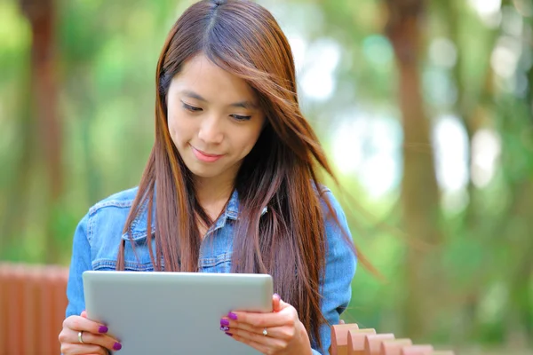 Jeune femme asiatique avec tablette ordinateur en plein air — Photo